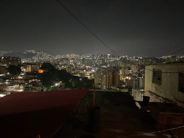 Nighttime rooftop view captured over Caracas residential area