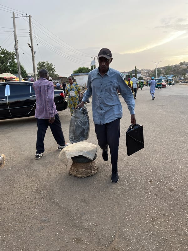 Street vendors sell yams and goods in Kabong, Nigeria