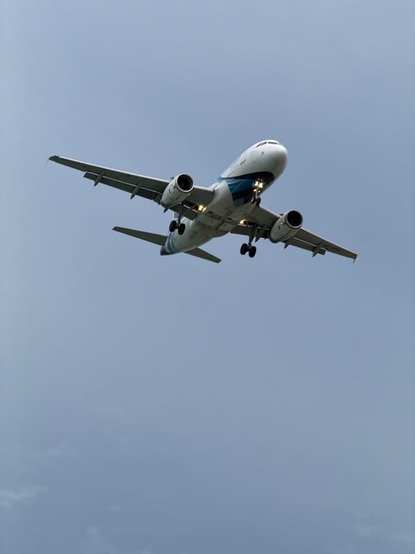 Plane on final approach over Ko Samui ferry dock