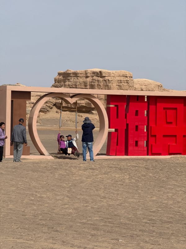 Tourists explore Dunhuang desert attractions and heart-shaped photo spot