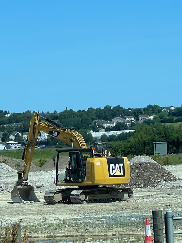 Caterpillar excavator on a clear-sky construction site in Letterkenny