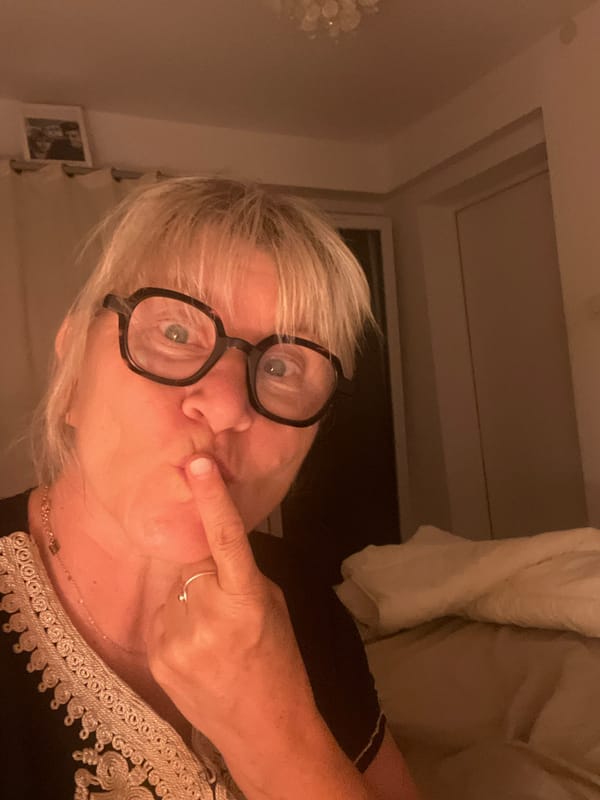 Finger to lips, shushing gesture in Chambœuf, France