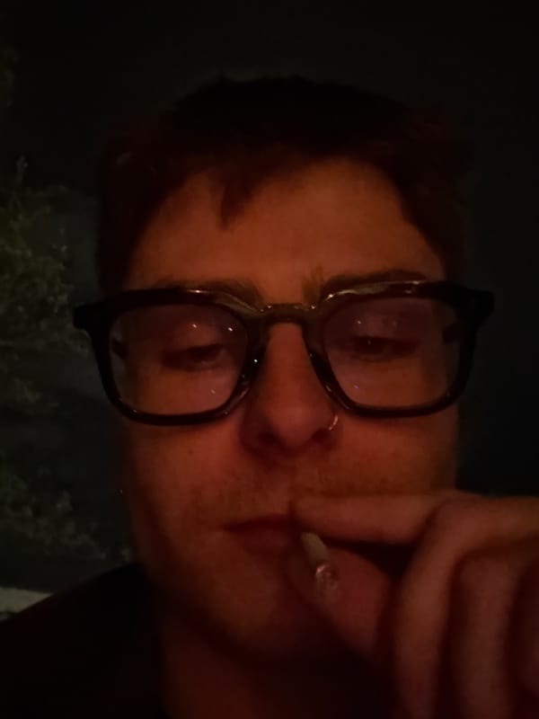 London resident enjoys quiet evening gaming and drinking at home