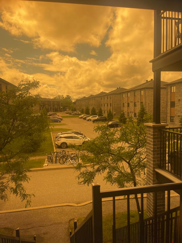Balcony evening in Gatineau under a smoke-tinged orange sky