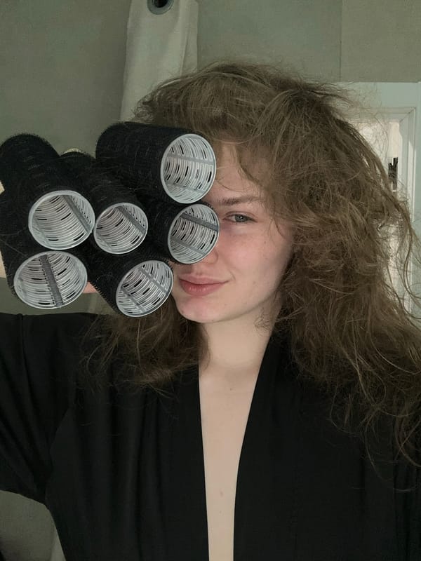 Woman uses hair rollers during beauty routine in Kazan