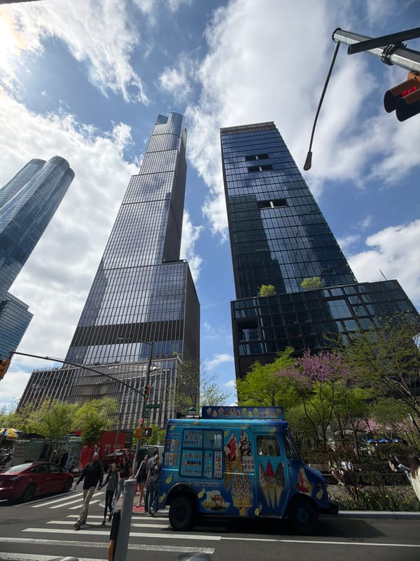 NYC street scene with skyscrapers and ice cream vendor observed
