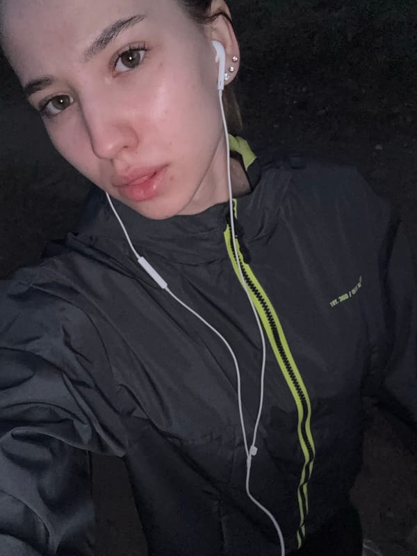 Woman takes selfie portrait in dimly lit Noviy, Russia