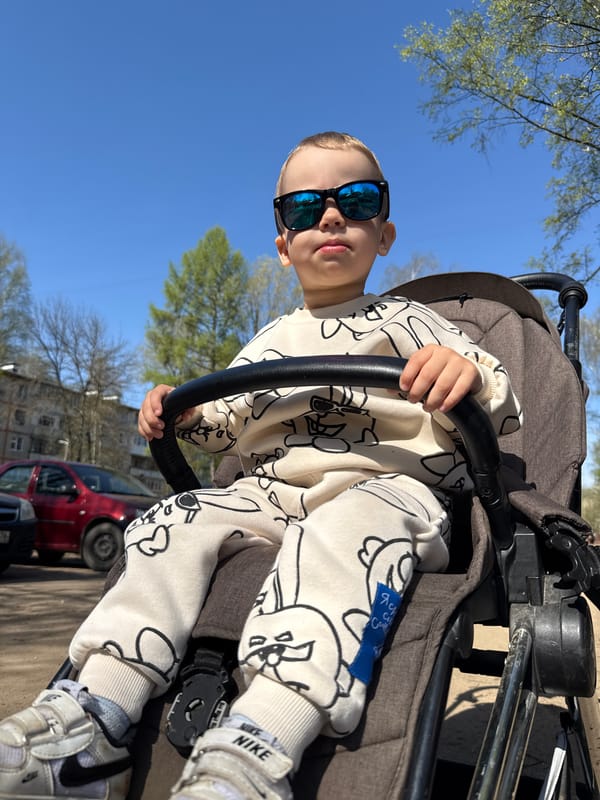 Mother and child enjoy morning stroller outing in Rusanovo