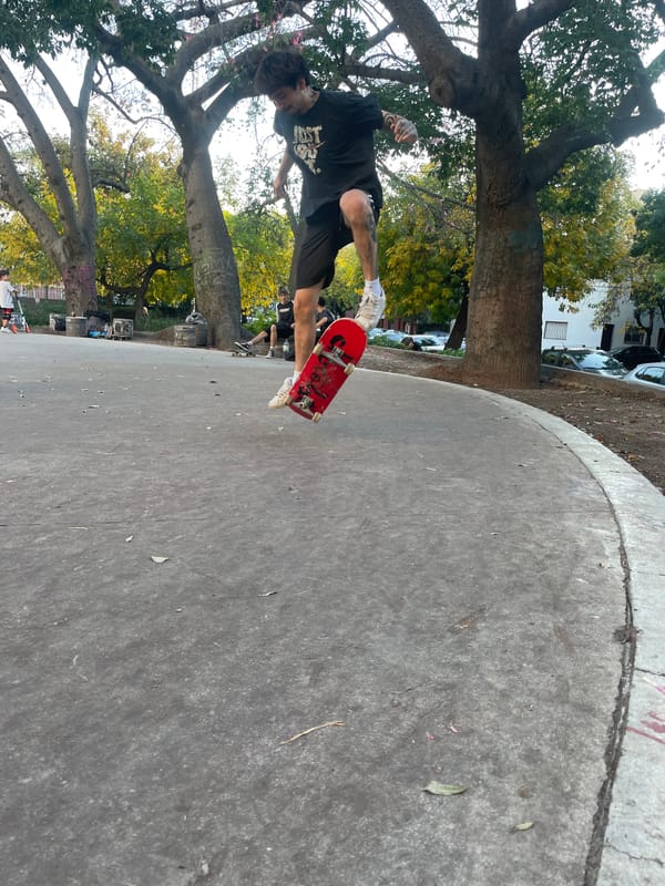 Skateboarder performs aerial tricks at Buenos Aires park