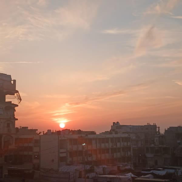 Sunset documented over Gaza refugee camps and damaged buildings