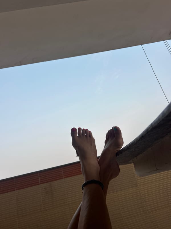 Low-angle photos capture feet and architecture in Puttaparthi