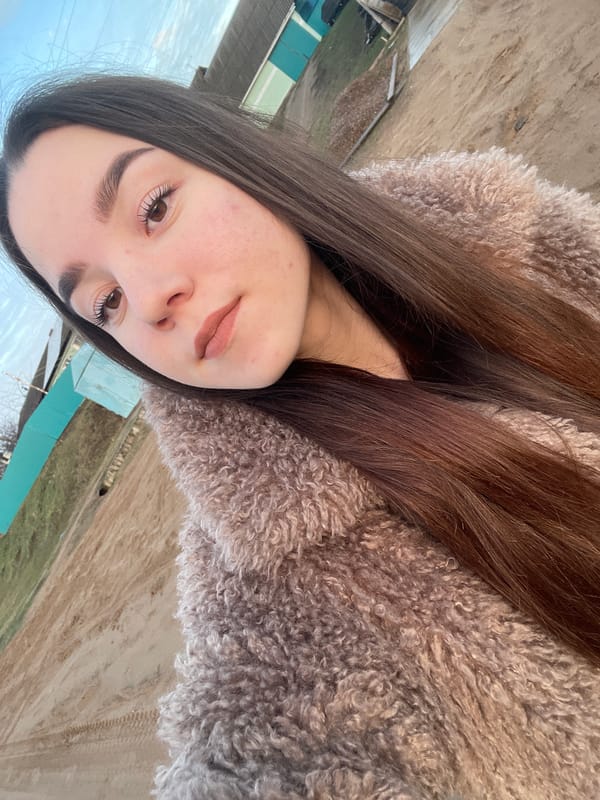 Woman takes selfies during golden hour in rural Russia