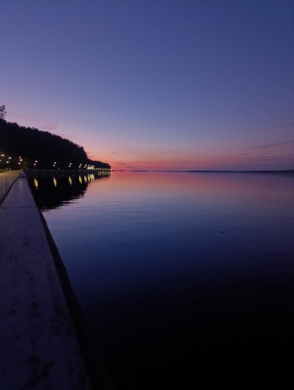 Evening skateboarding session documented along waterfront during twilight hours