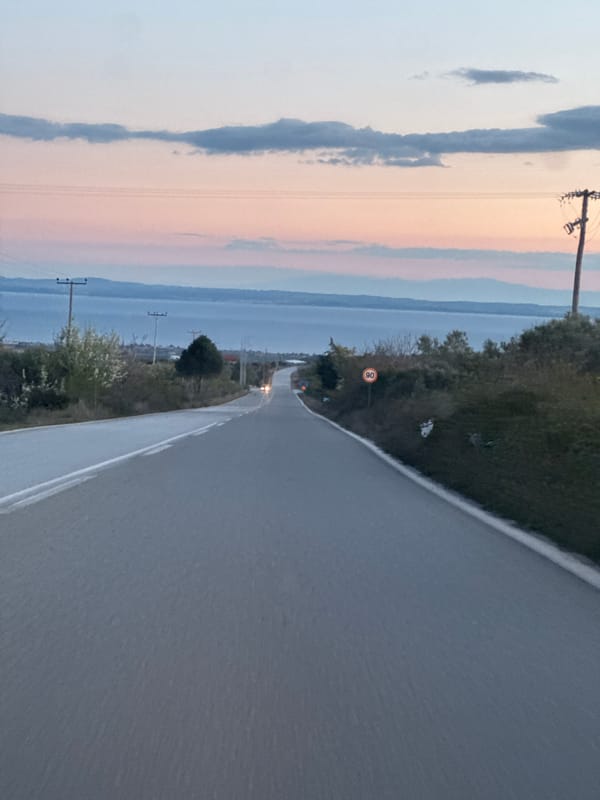 Hillside road with speed limit sign near Polygyros