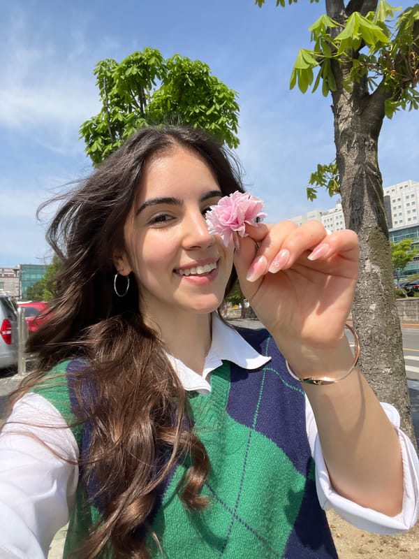 Woman takes cherry blossom selfies in nighttime Daegu