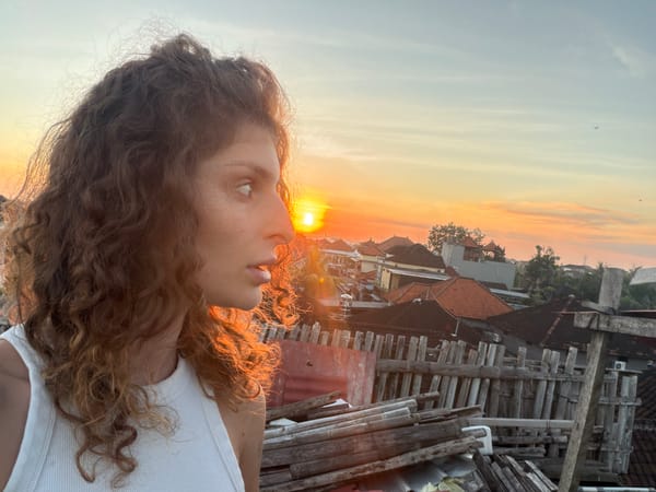 Tattooed woman captures sunset selfie session on North Kuta rooftop