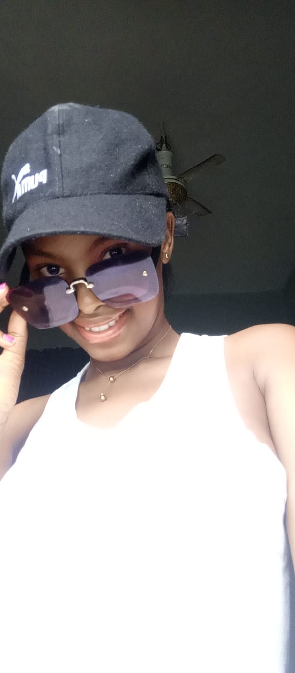 Woman and infant photographed wearing sunglasses in Keffi, Nigeria