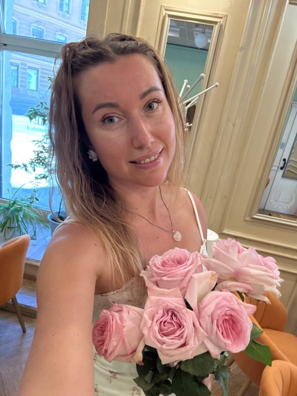 Woman takes selfies with roses near St. Petersburg canal