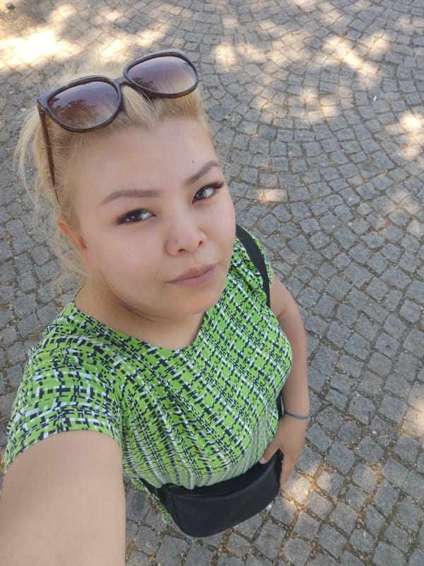 Woman documents sunny walking tour through historic Sarıyer district, Istanbul