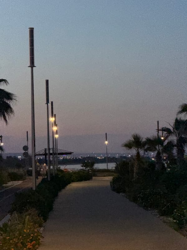Witness documents twilight coastal promenade scene in Meneou, Cyprus