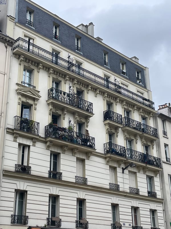 Ordinary morning life documented on classic Parisian street