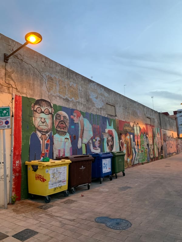 Valencia's street art scene at dusk, murals and graffiti throughout.