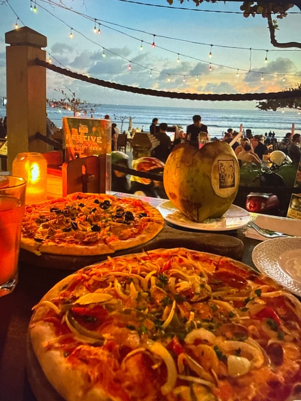 Beachside dinner evening with seafood, pizza, and coastal views