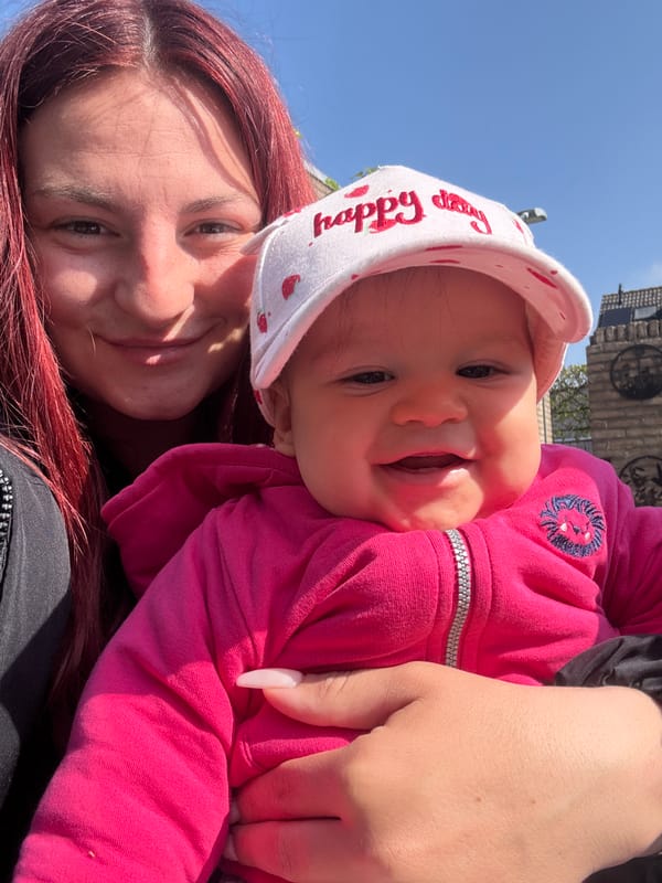 Mother feeds baby outdoors in Veghel during morning meal