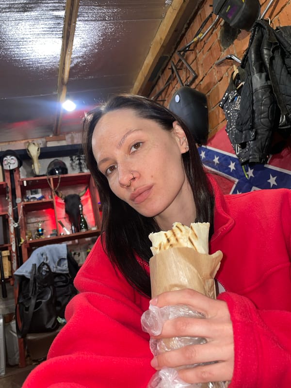 Woman eats kebab wrap in Oktyabr'skii, Russia