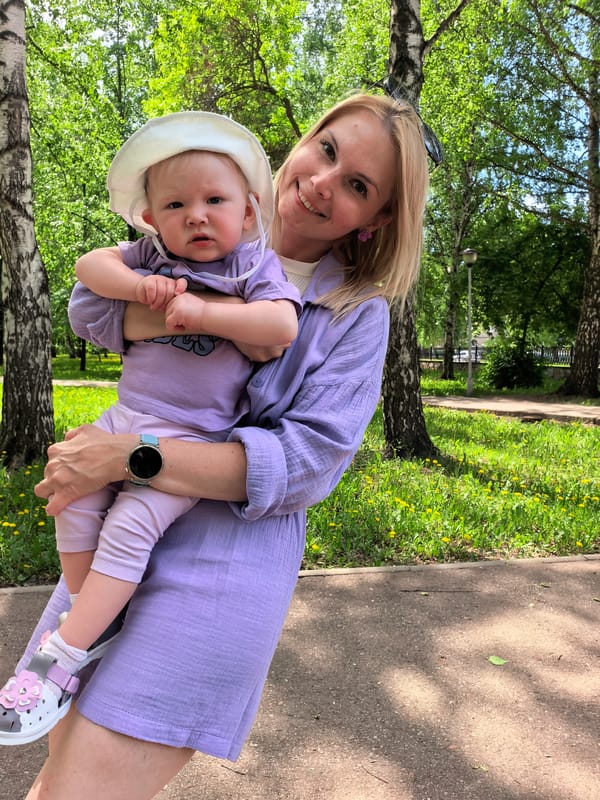 Woman with baby enjoys morning park visit in Sterlitamak