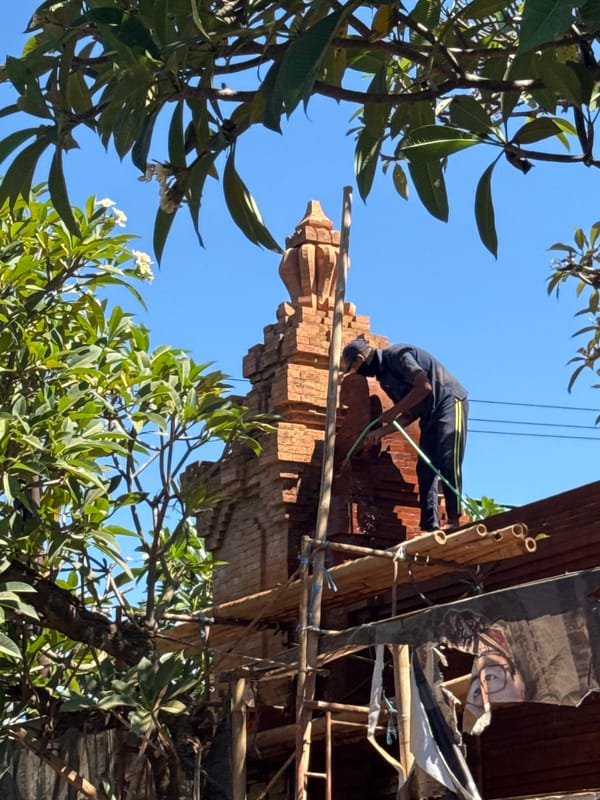 Construction worker builds brick structure in Denpasar, Indonesia