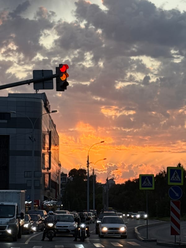 Dramatic sunset over Yekaterinburg streets, clouds lit in orange and pink