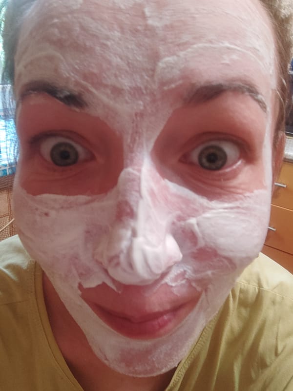Person applies white facial mask in Smolensk selfie