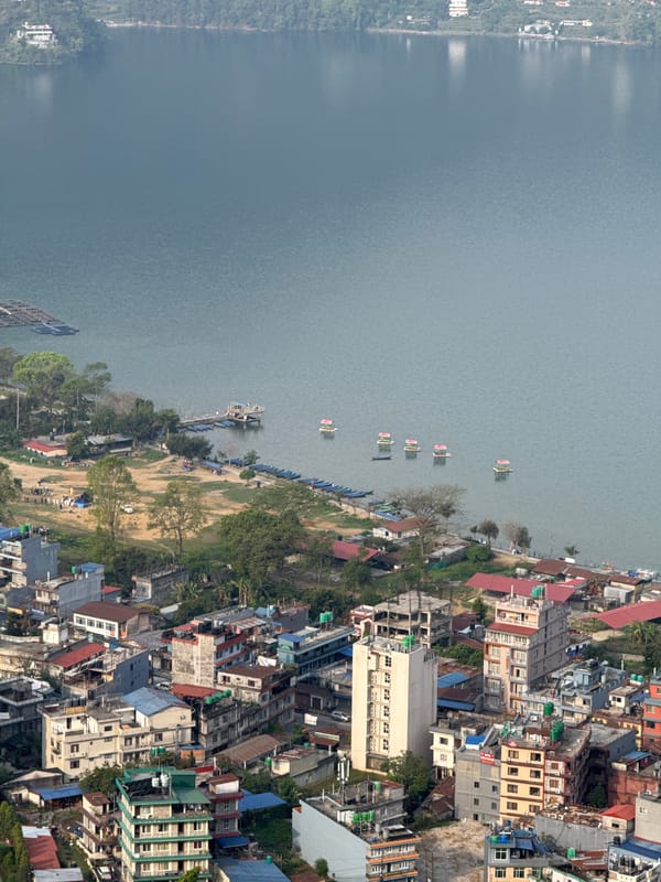 Small yellow plane flies over Pokhara Nepal early morning