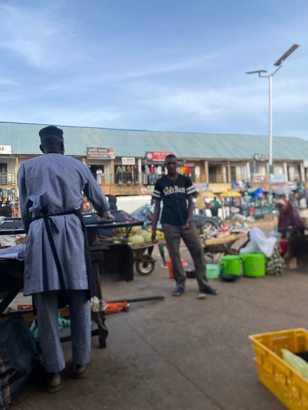 Daily life unfolds in Bukuru Nigeria marketplace during afternoon