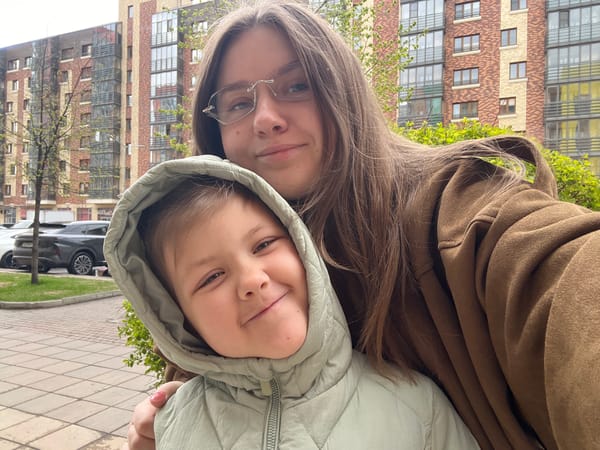 Mother and child share morning sidewalk moment in Krasnoyarsk