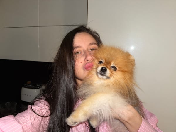 Woman plays with Pomeranian dog in Khimki home