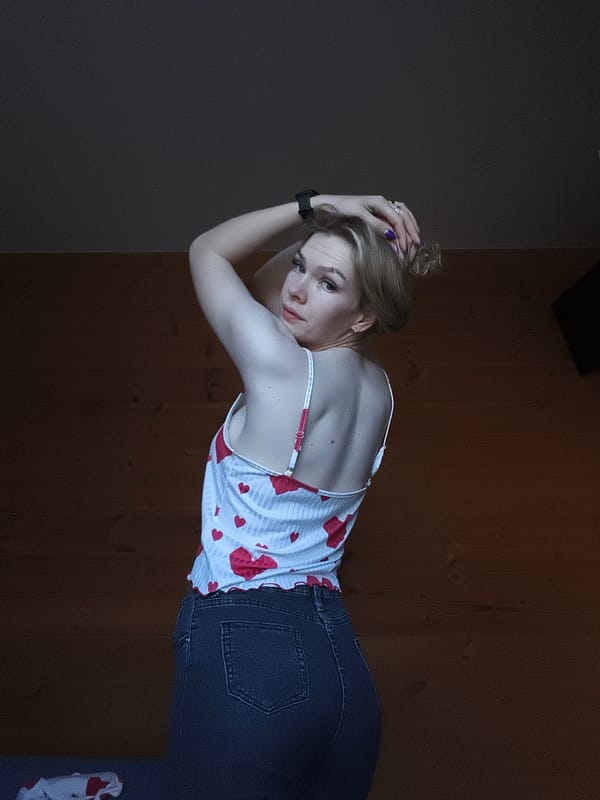 Woman poses for indoor photograph in Russian village