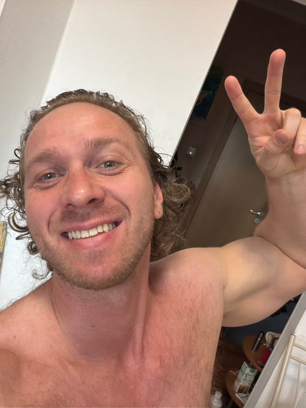 Man takes smiling selfie with peace sign in Saint Petersburg