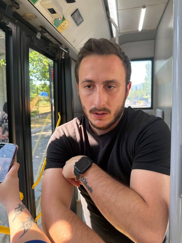 On a Tbilisi bus, a passenger and a bilingual window sign