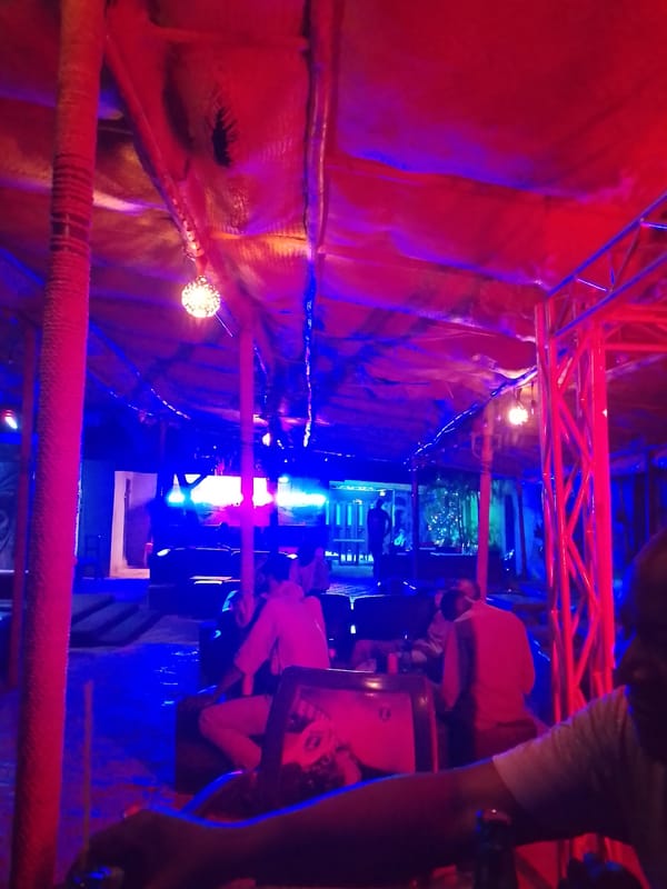 Evening gathering at atmospheric bar with distinctive lighting