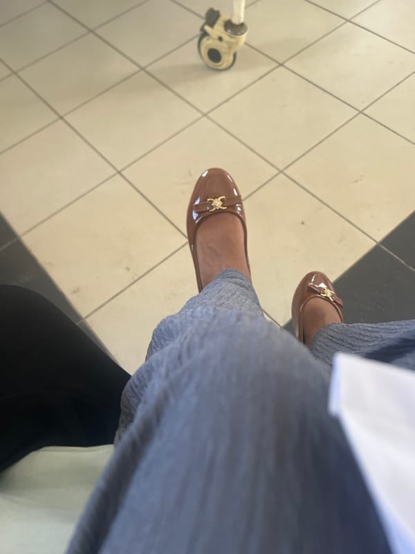 Person in ballet flats sits near medical device in Tanzania