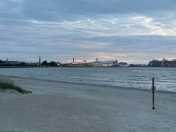 Tallinn's Baltic waterfront at dusk, cruise ships in the bay