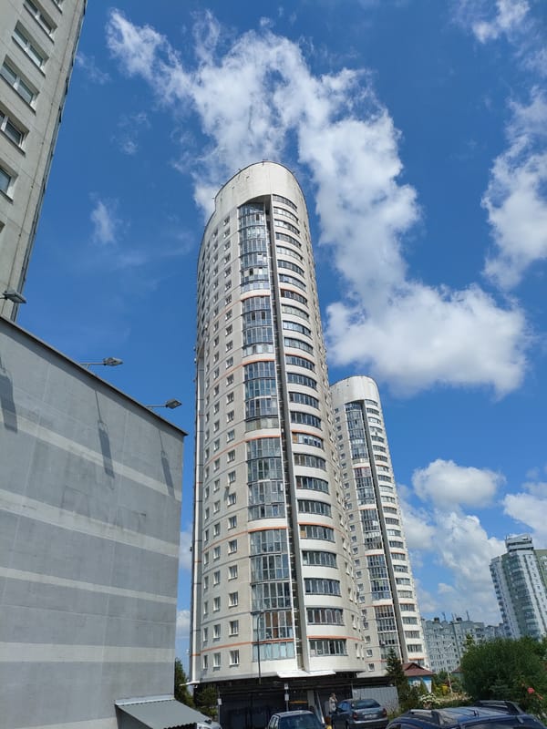 Modern high-rise residential towers under blue skies in Minsk
