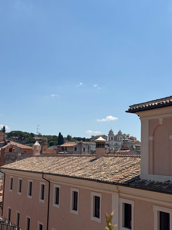 Rooftops and a gelato cart on a sunny Rome morning
