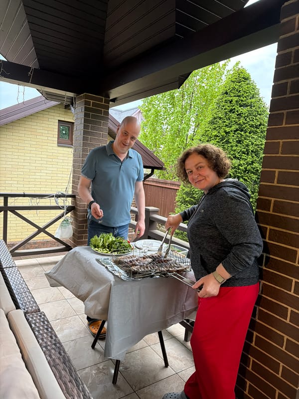 Rain-soaked backyard barbecue gathering documented in suburban Russia