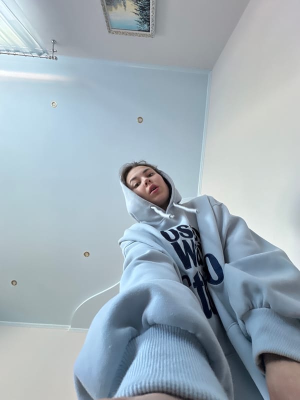 Person in blue hoodie observed indoors in Ilyinsky, Russia