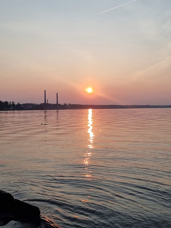 Sunset over the Kama River, Chaykovsky industrial skyline in silhouette