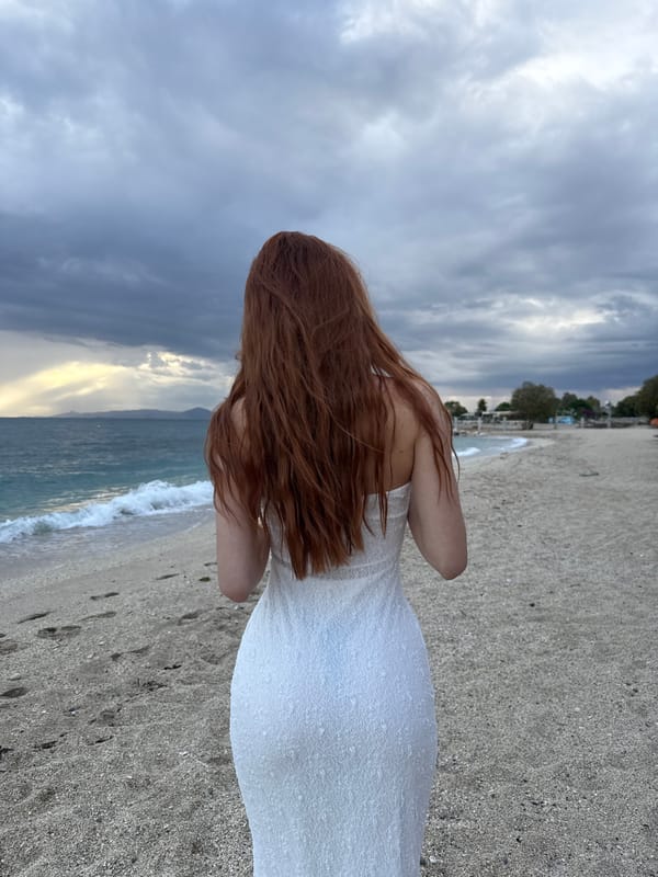 Woman in white dress spotted on overcast Alimos beach