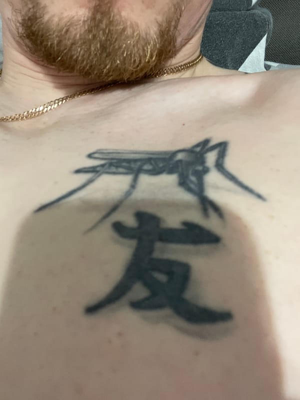 Bearded man photographed in bedroom showing climbing tattoo, Sarapul